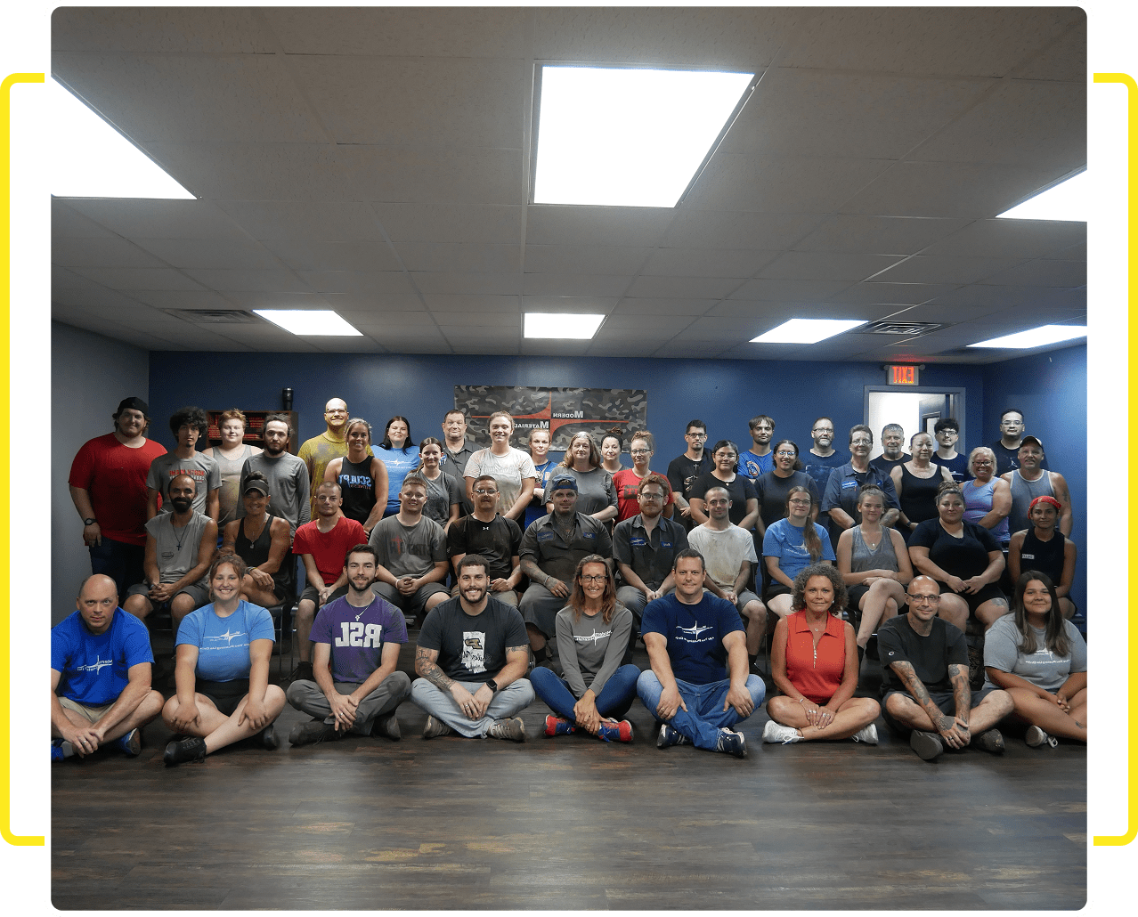 Team gathering indoors under bright lights