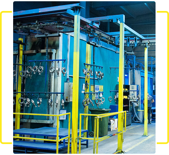 Industrial machinery with pipes and gauges in a factory setting.