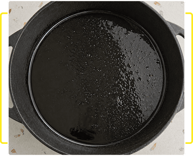 Cast iron skillet with oil heating inside.